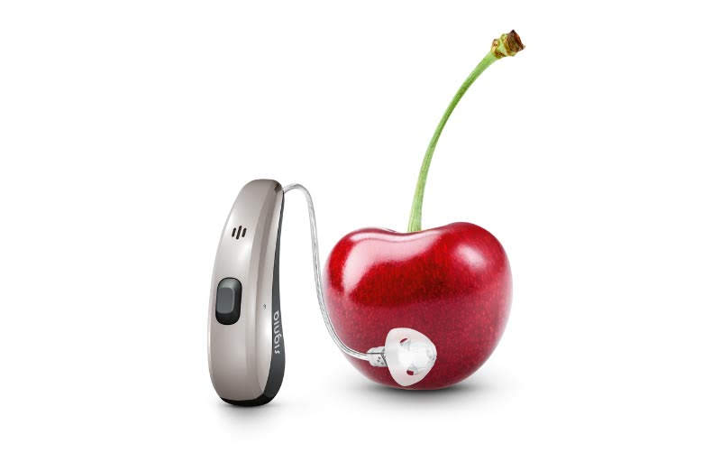 Signia Pure Charge & Go beside a Cherry